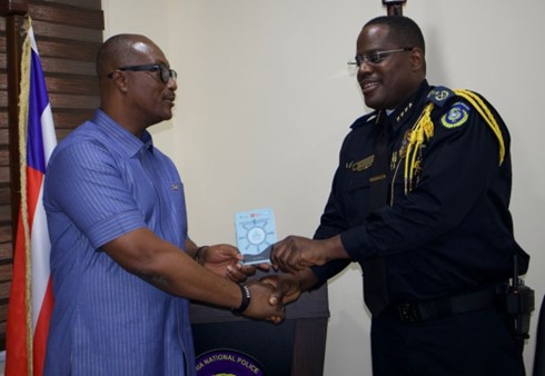 Air Cdre David Akrong shares a copy of the Maritime Code of Practice with the Inspector General of Police for Liberia